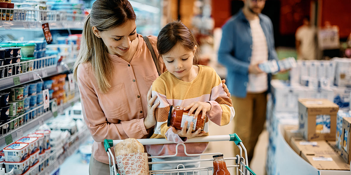 A mother shopping at the supermarket with her daughter