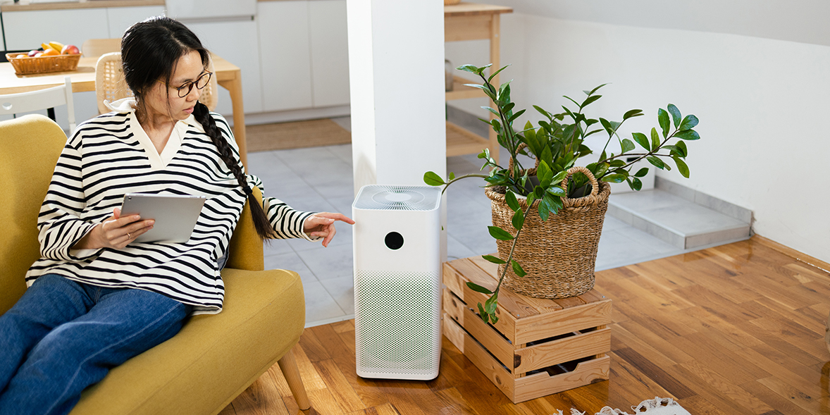woman using an air purifier
