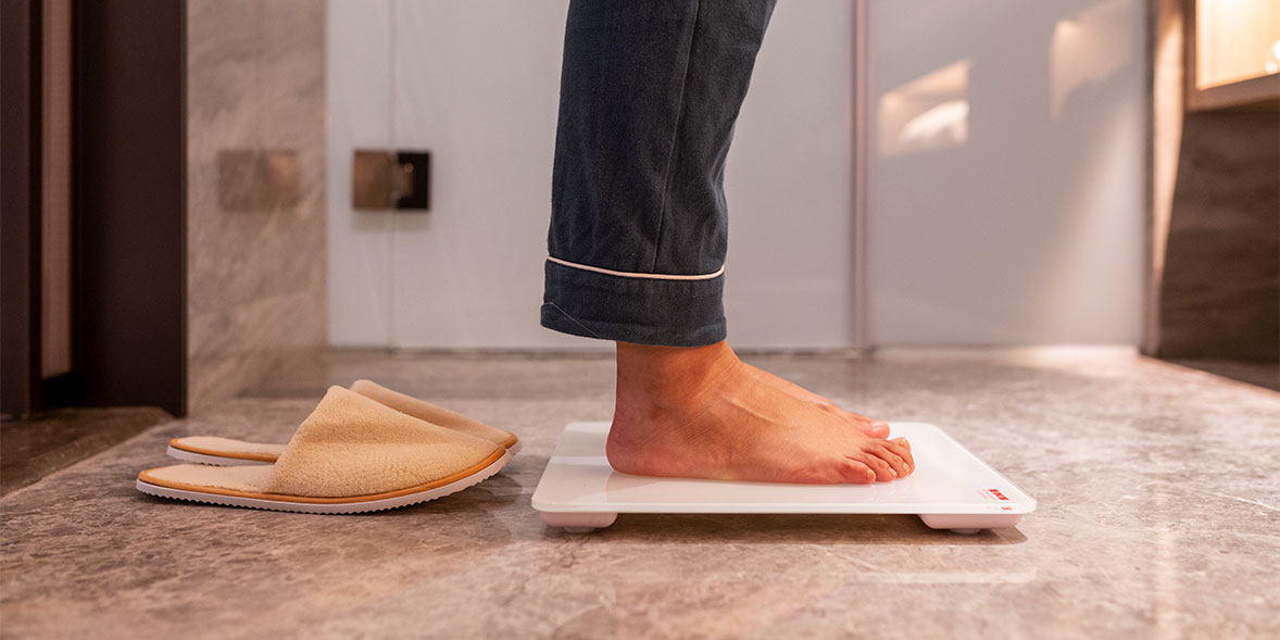A person stepping onto scales