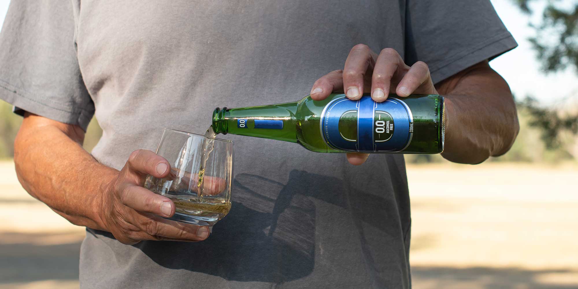 Man pouring alcohol free beer into glass