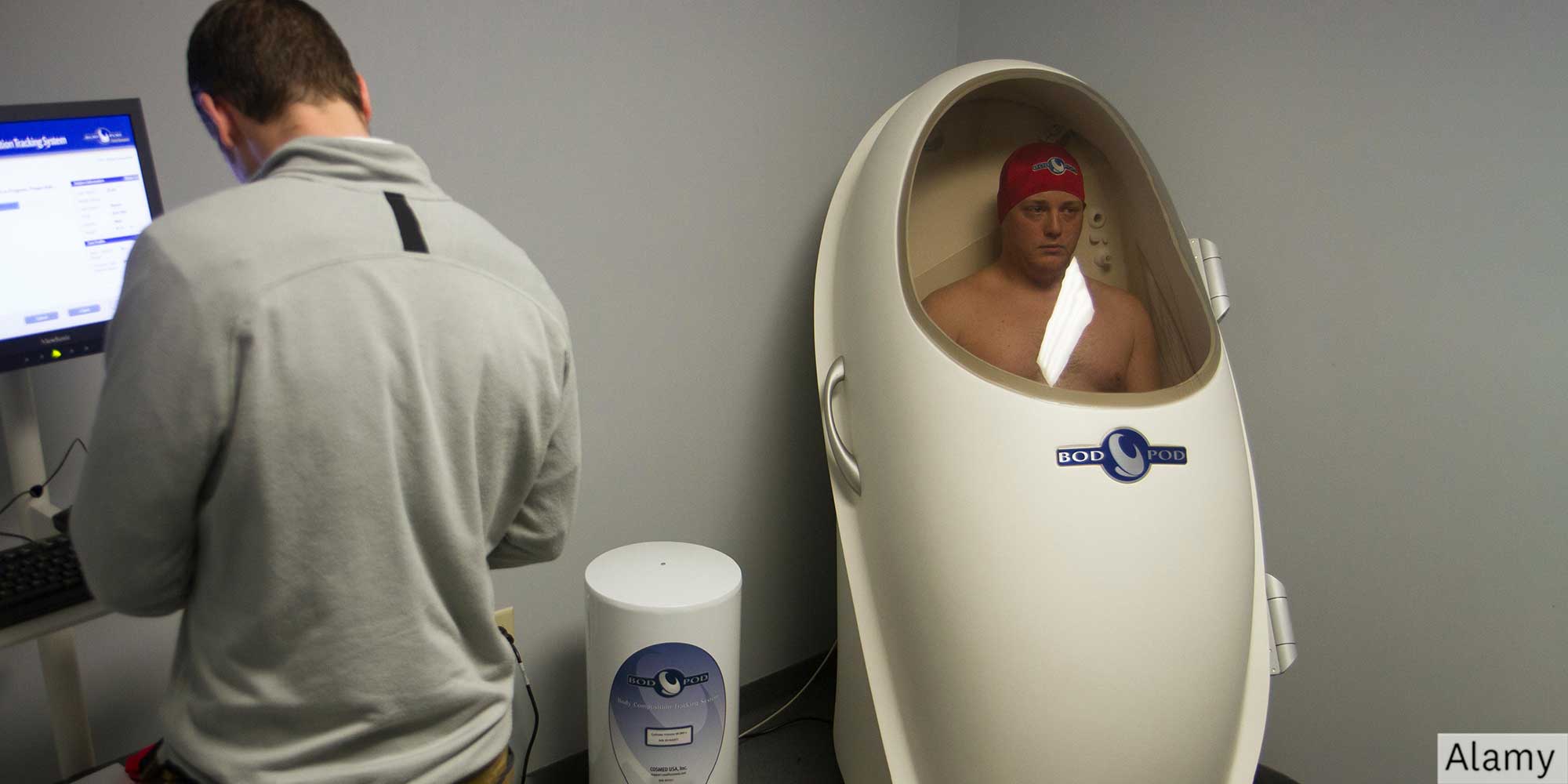 A man inside a white pod shaped chamber
