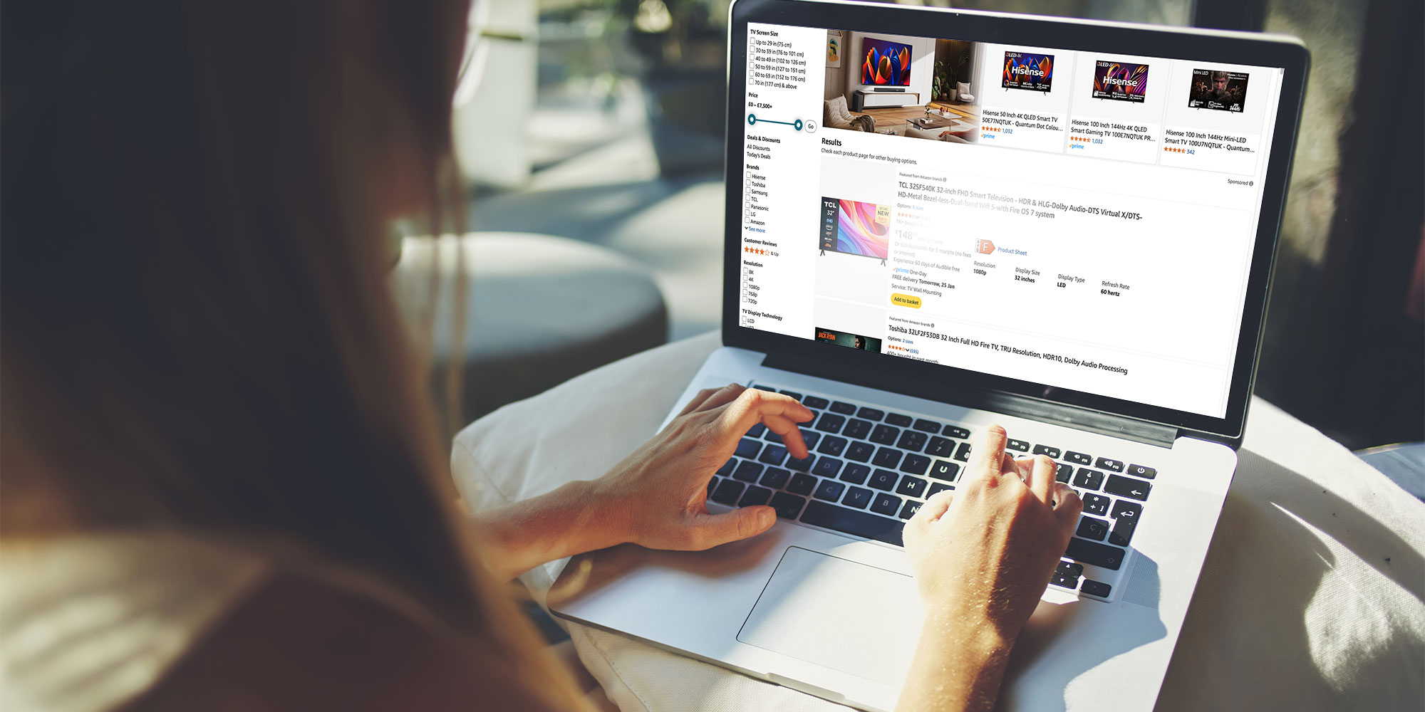 Woman shops for a TV on her laptop