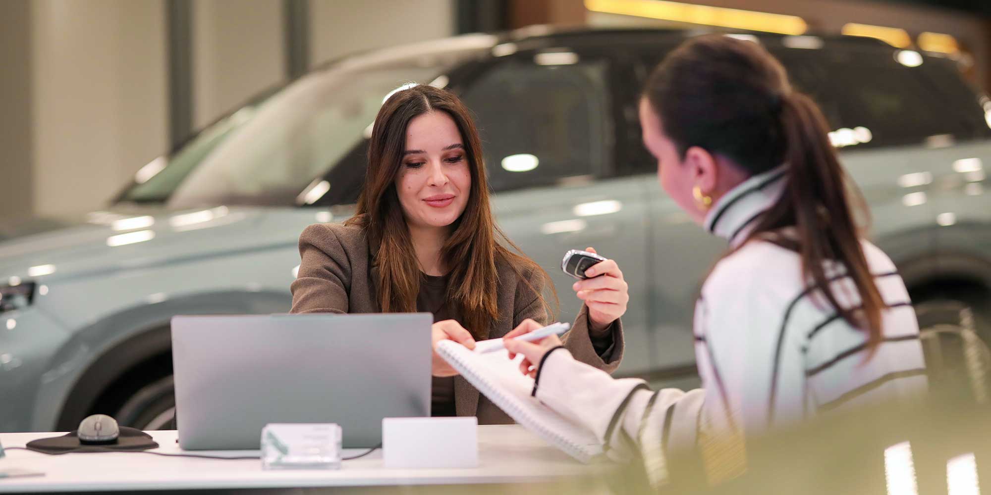 Someone signing for a car