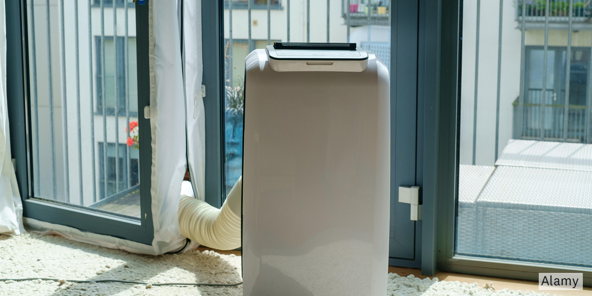 Air conditioner with hose going out of the patio door