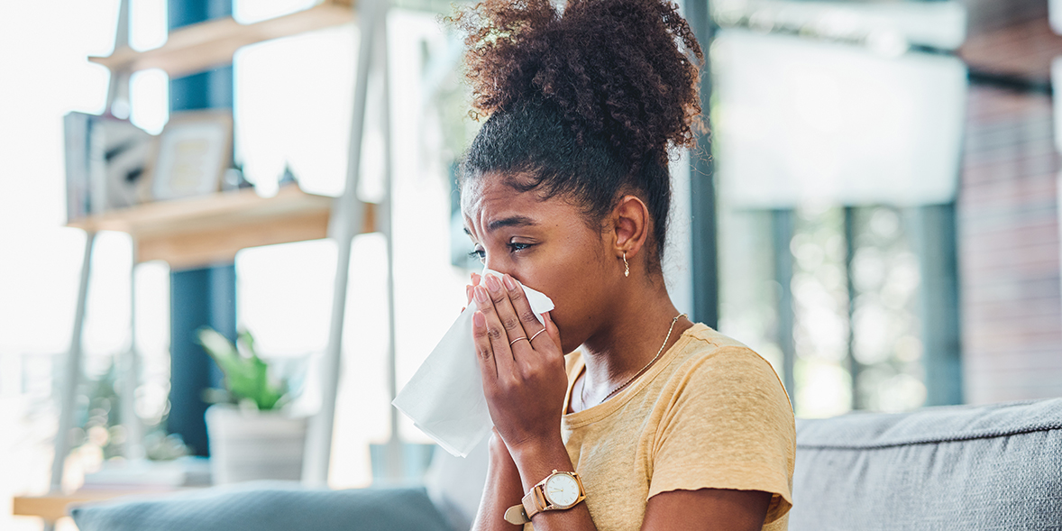 woman suffering from hay fever at home